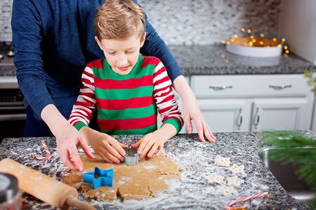 family of two, mother and her son, enjoying winter time at home and making cookies from scratch together, christmas time conceptの写真素材