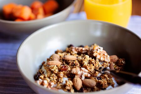 bowl of crunchy granola with nuts and dried fruits for breakfast, gourmet hotel breakfastの写真素材