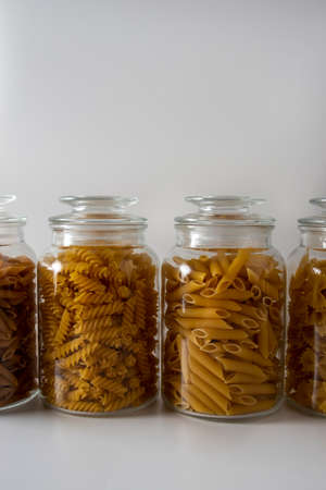 Different types of italian pasta standing next to each other in a glass jarsの写真素材