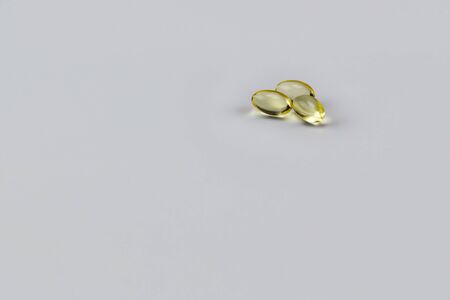 Vitamin E Pills Capsules White Background Isolated three pillsの写真素材