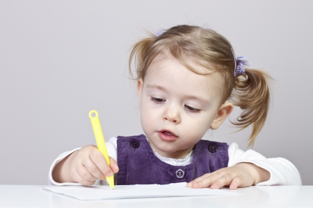 Cute little girl learning to drawの写真素材