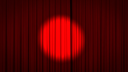 Red stage curtain with a spotlight in the center.の写真素材