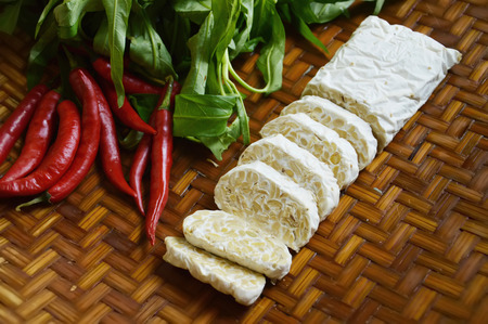 tempe, chili and water spinach on bamboo plaitの写真素材