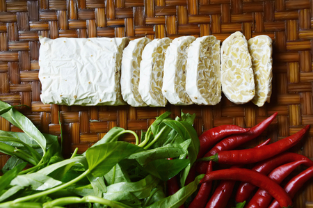 tempe, chili and water spinach on bamboo plaitの写真素材