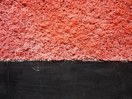 texture of the walls with bright red and black colors for backgroundの写真素材