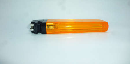 Close-up photo of yellow lighter (white background)
