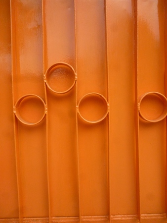 Stylish orange metal fence as backgroundの写真素材
