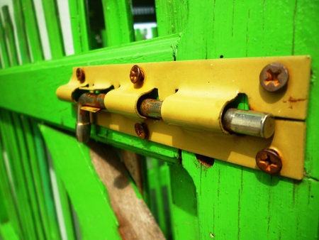 lock key with green wood backgroundの写真素材