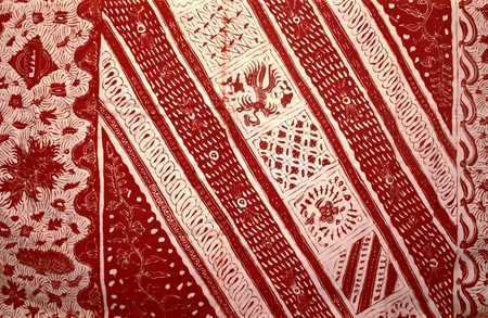 a close up shot of a batik hand stamp print with it its intricasy in the design motif batik is...