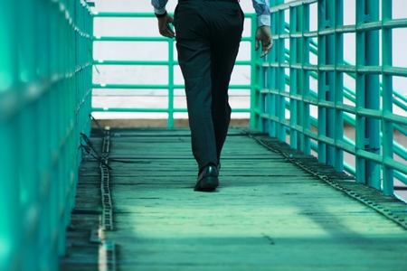 man walking on sidewalkの写真素材