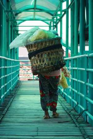 seller of vegetables in the traditional market pasar in Indonesia on the semarang central javaの写真素材