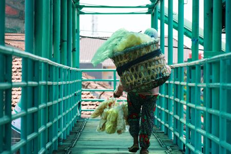 seller of vegetables in the traditional market pasar in Indonesia on the semarang central javaの写真素材