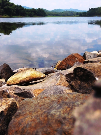 Landscape view of the hills and valley clearly reflected in the bright blue lakeの写真素材