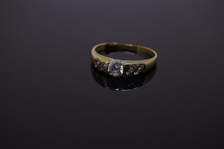 single wedding ring isolated on dark backgroundの写真素材