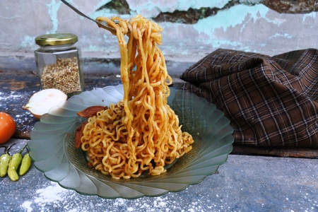fried noodles with various kitchen spicesの写真素材