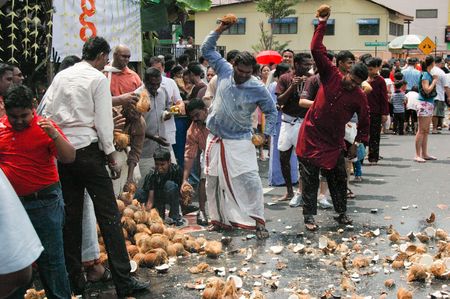Penang, Malaysia, Feb 2 2009. Devotees smashing coconuts in the street in anticipation of the arrival of Lord Murugan's chariot in the annual Thaipusam festival.のeditorial素材