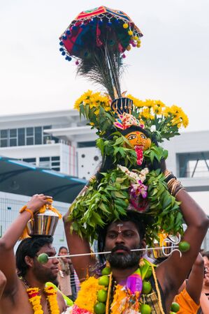 20 January 2011, Kuala Lumpur, Malaysia: A Hindu devotee walks with a skewered mouth as part of a popular devotion during the anual Thaipusam festival.のeditorial素材