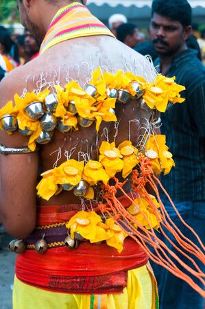 20 January 2011, Kuala Lumpur, Malaysia: A Hindu devotee carrying miniature milk pots on hooks...