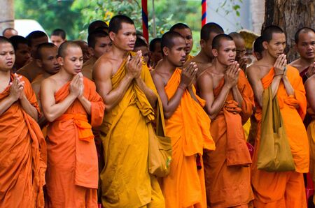 Siem Reap, Cambodia, 4 April 2012. A group of Cambodian monks standing in prayer.のeditorial素材