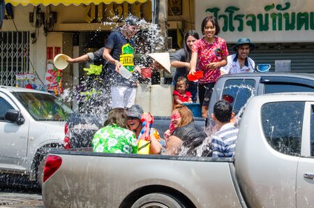 Bangkok, Thailand, 14 April 2015. Groups of festival goers celebrate Songkran by tossing buckets of water on each other while riding on the backs of trucks. The annual Songkran water festival is marked by splashing water on each other.のeditorial素材