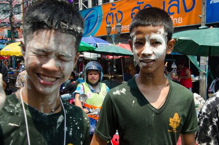 Bangkok, Thailand, 14 April 2015. A pair of teenage boys with faces painted with mud at the Songkran festivities in Khao San Road. Partygoers smear each otherのeditorial素材