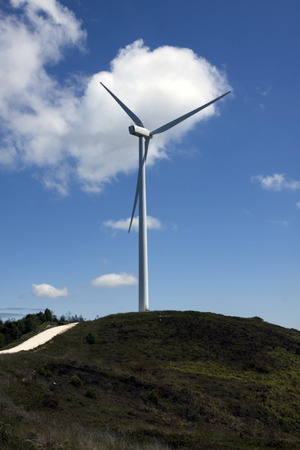 a back detail turbine of a wind farm with a blue sky