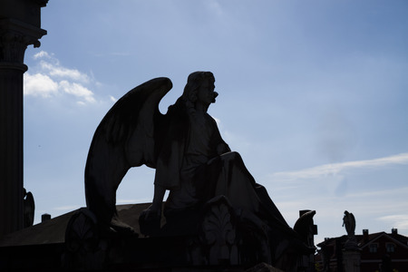 a  backlight esculture of an angel with a big wings