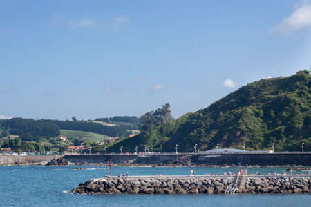 a magnificent view of a landscape of mountain and sea beach in summerの写真素材