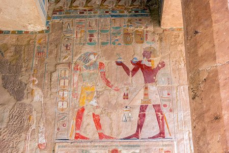 horizontal view of some colored ancient egypt images on wall in luxor