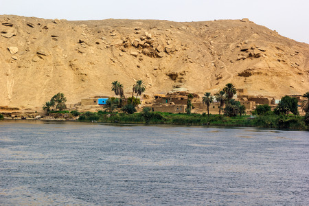 a horizontal view of a little village at he banks of the Nile riverの写真素材