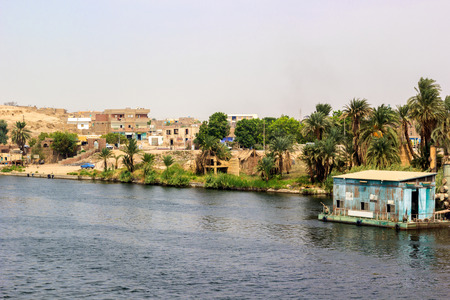 a horizontal view of a little village at he banks of the Nile riverの写真素材