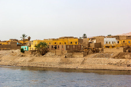 a horizontal view of a little village at he banks of the Nile riverの写真素材
