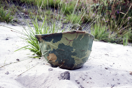 a horizontal view of an American helmet of the Vietnam war over the floorの写真素材