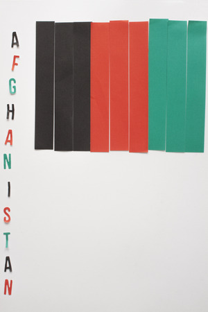 a vertical view of a flag from Afghanistan made by paper stripes with its nameの写真素材