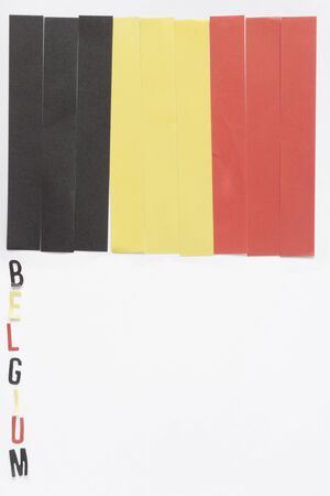 a vertical view of a Belgian flag made by paper stripes wit its nameの写真素材