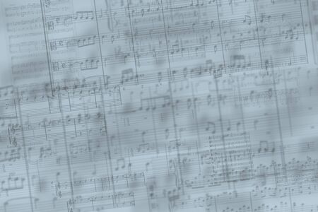 layers of musical notes against a gray-blue backgroundの写真素材