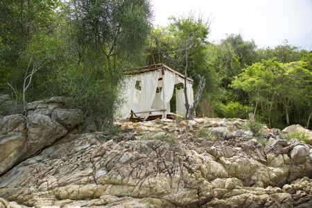 Bungalow on a rocky beach