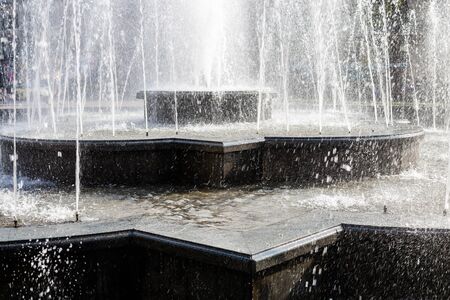 Splash and drops in a spring fontain. Water falling, close up shot. Fontain water details.の写真素材