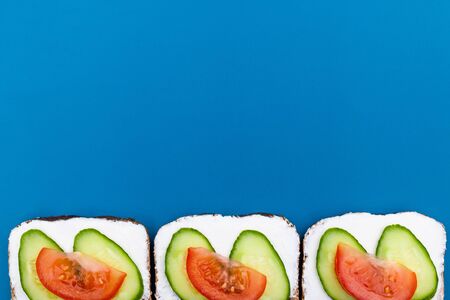 Sandwich menu concept, summer sandwiches on blue background, with copy space, top view.の写真素材