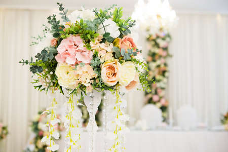 Wedding decoration on table. Floral arrangements and decoration. Arrangement of pink and white flowers in restaurant for luxury wedding event.の写真素材