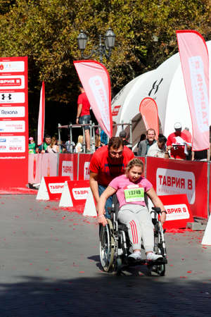 ODESSA, UKRAINE - CIRCA SEPTEMBER, 2019: Female wheel chair competitor at half-marathon in Odessa. Concept of disabled and sports.のeditorial素材