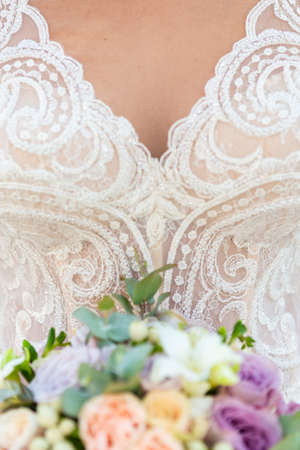 Bride with bouquet, closeup view. Wedding bouquet, wite dress on background.の写真素材