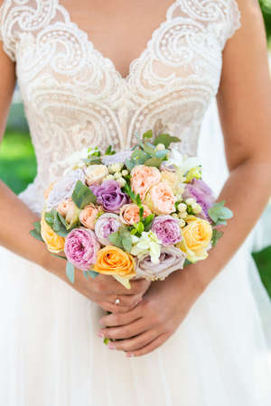 Bride with bouquet, closeup view. Wedding bouquet, wite dress on background.の写真素材