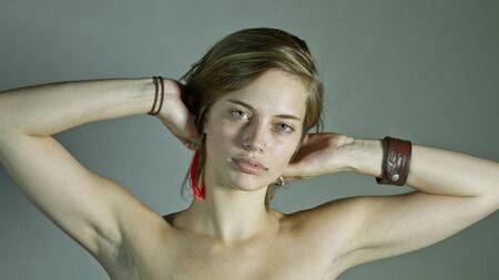 Tired Young Woman Holding Head With Both Handsの写真素材