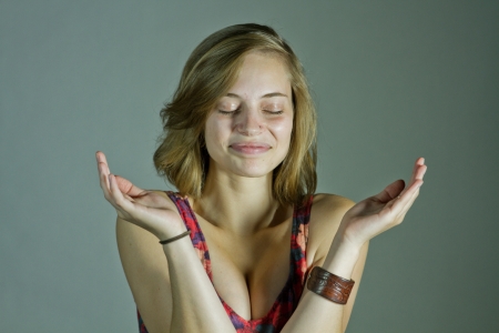 Young Woman With Eyes Closed Smiling and Clappingの写真素材