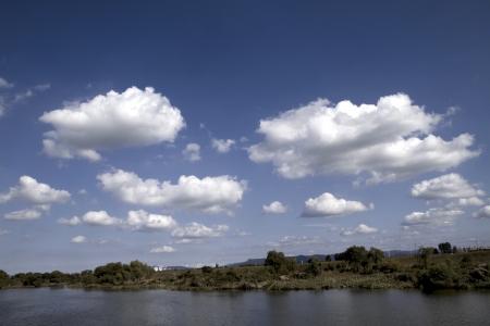 Clouds Over a Field and Riverの写真素材