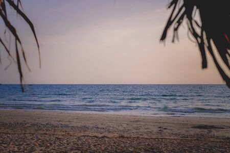 Beautiful sunset over the sea with a view at palms , Landscape, Thailand.