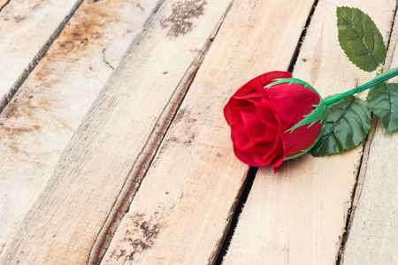 Red rose on wooden background with coppy spaceの写真素材
