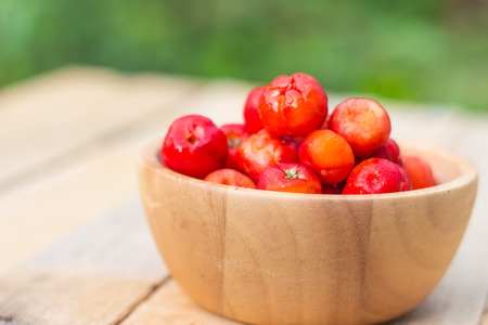 Cherry red color in wooden bowls. sofe focusの写真素材