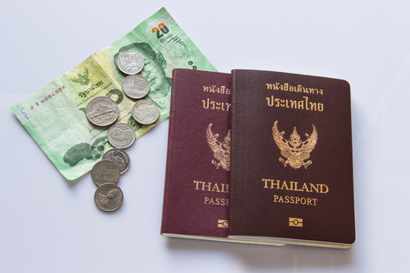 Paper money,coins,passport Thailand on white background.の写真素材